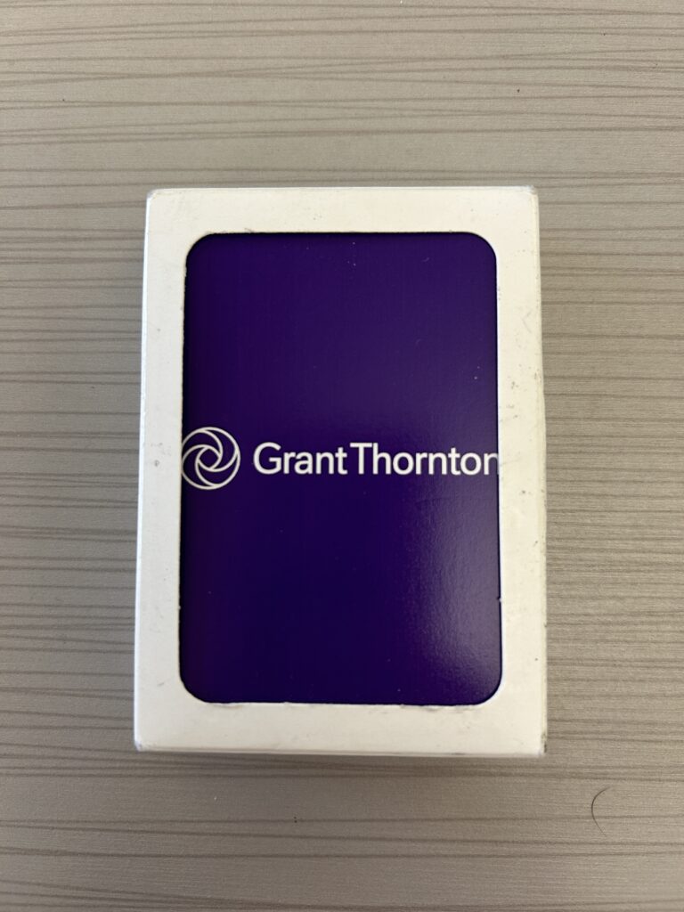 A deck of purple playing cards with the logo of Grant Thornton.