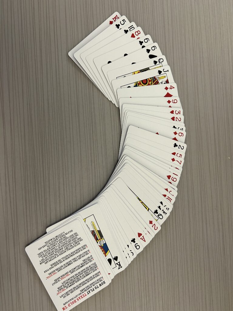 A set of playing cards fanned out on a table, ready for a game.