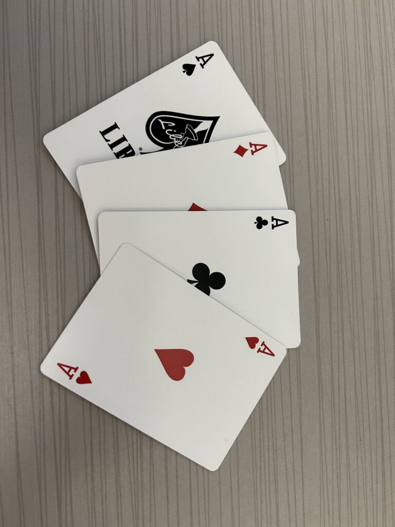 Four aces from a deck of cards, displayed in a fan arrangement.