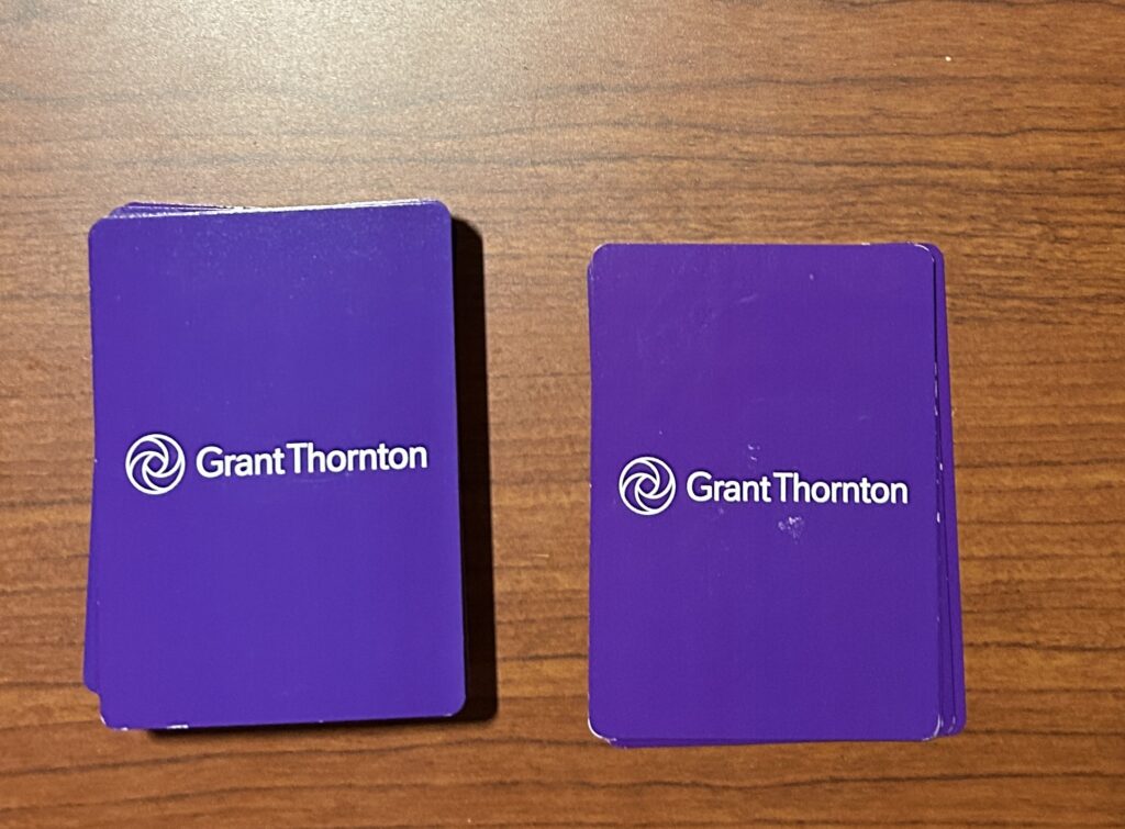 The deck is placed on the left side of the desk, and the five cards on the right side of the desk. Both piles have the front of the cards displaying the suits face down.