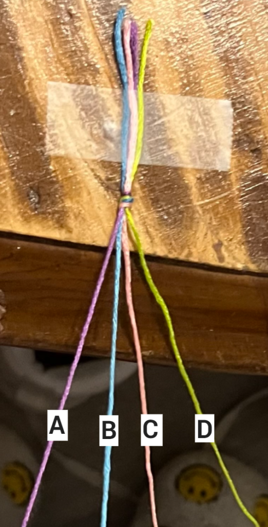 This photo represents the start of the friendship bracelet before any candy stripe knots are made. This helps readers follow along and understand what it should look like initially.