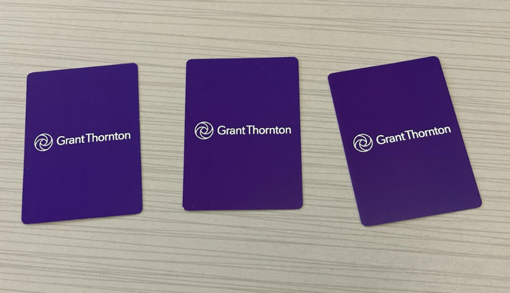 Three cards are on the table, being distributed from the deck. The cards have the front of the cards displaying the suits face down.