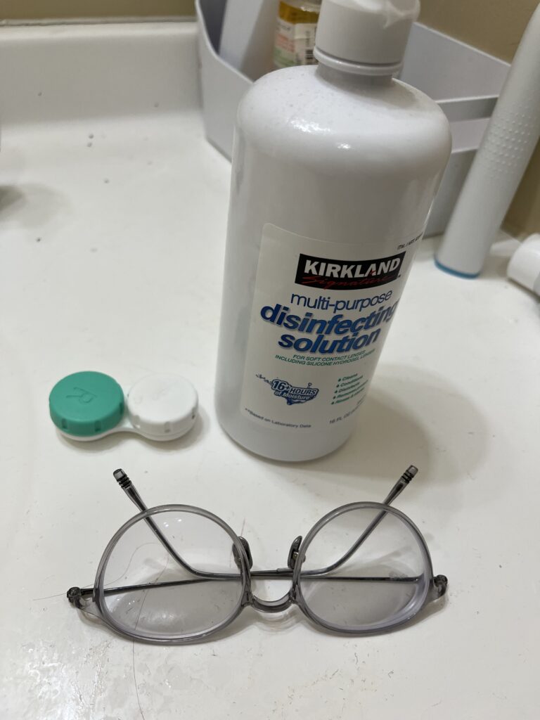 Three essentials for contact lens wearers. Glasses, Contact case, and contact solution